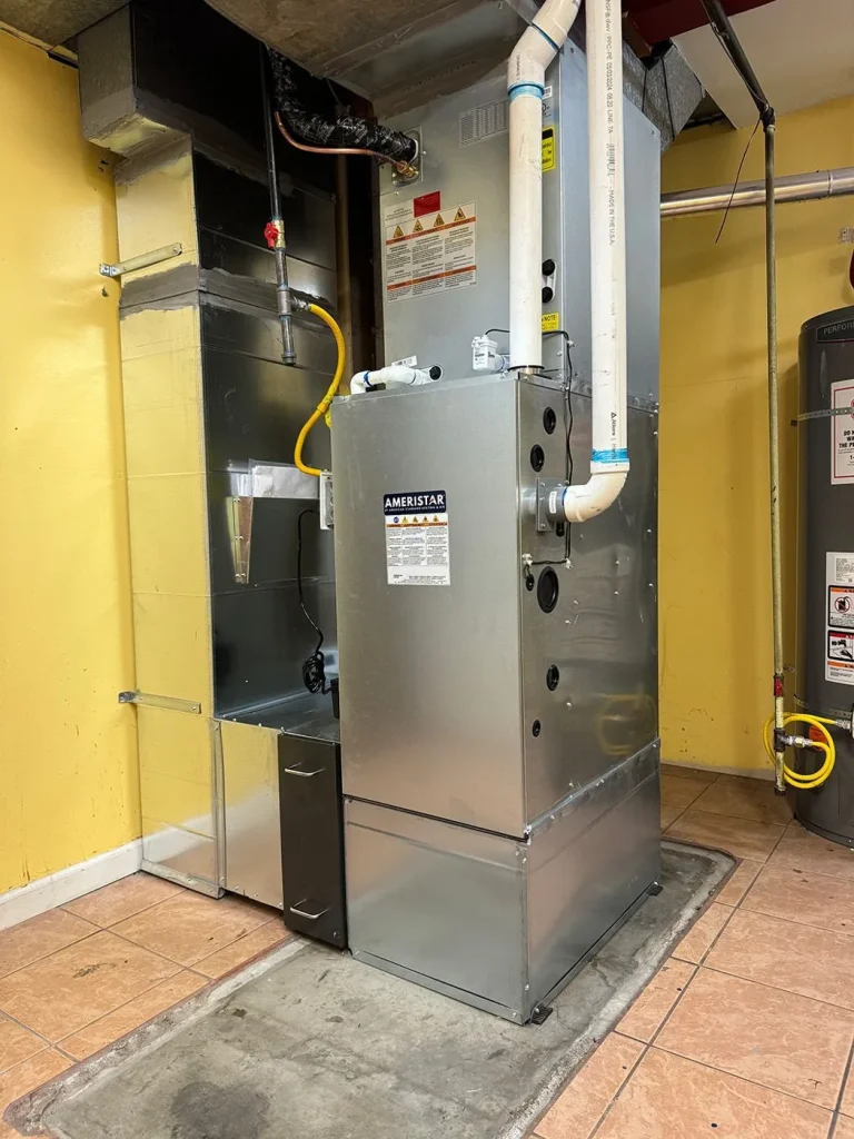 Gas furnace and water heater installed together in a Seattle area utility room.
