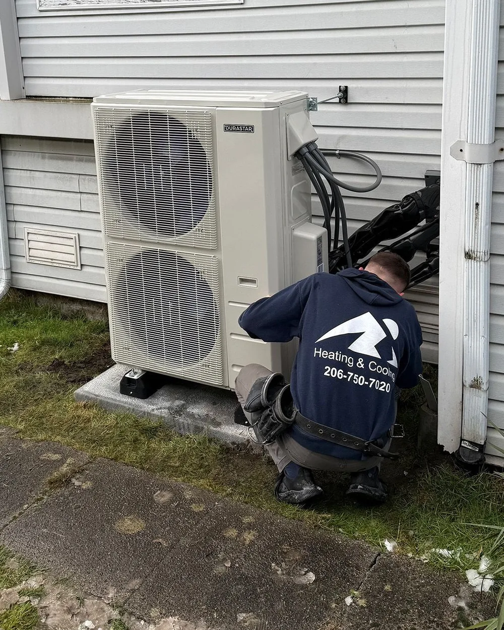 Ready Energy Solutions technician servicing a heat pump at a home near Seattle, Washington.