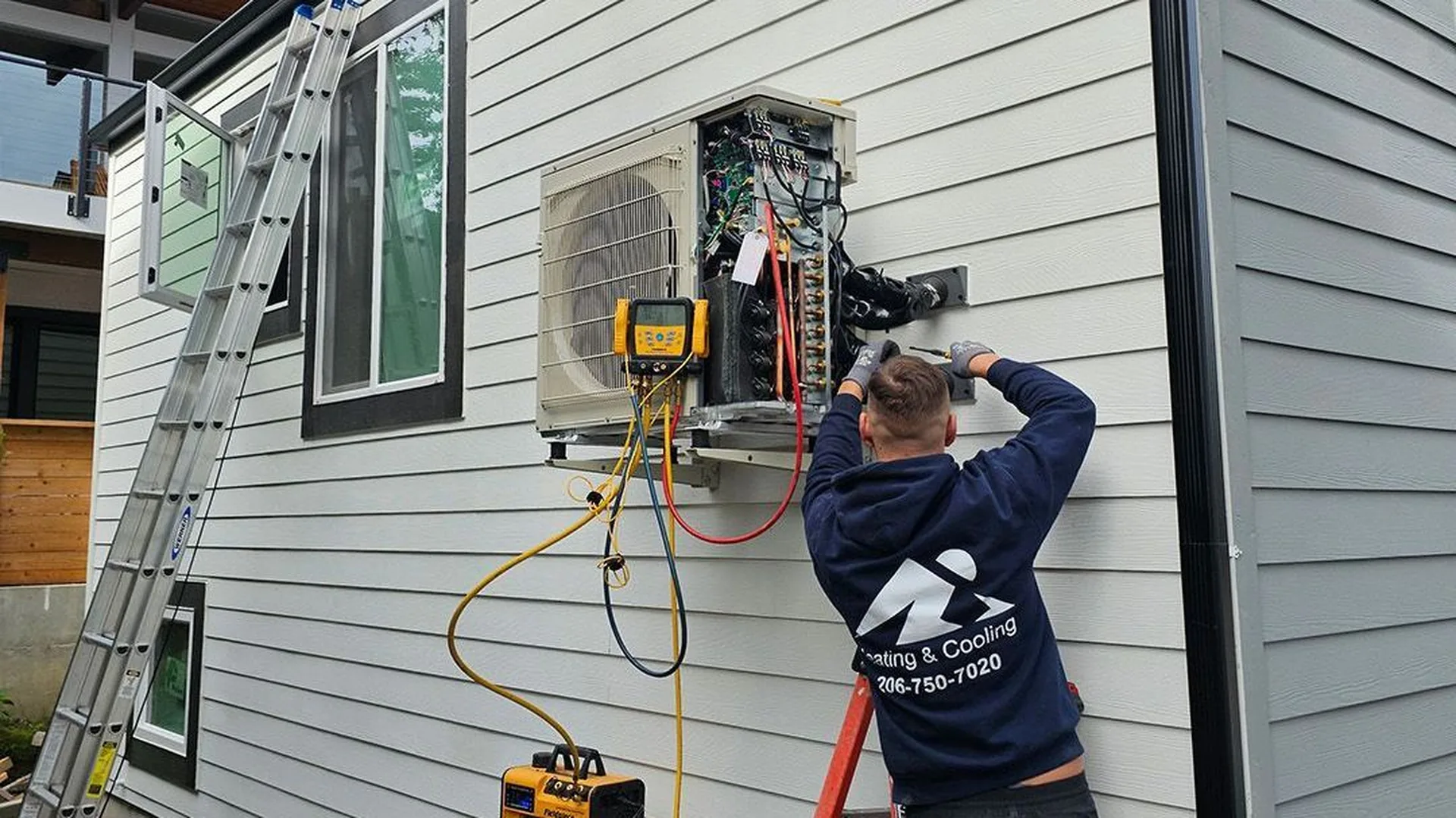 Ready Energy Solutions technician installing a ductless heat pump at a home near Seattle, Washington.