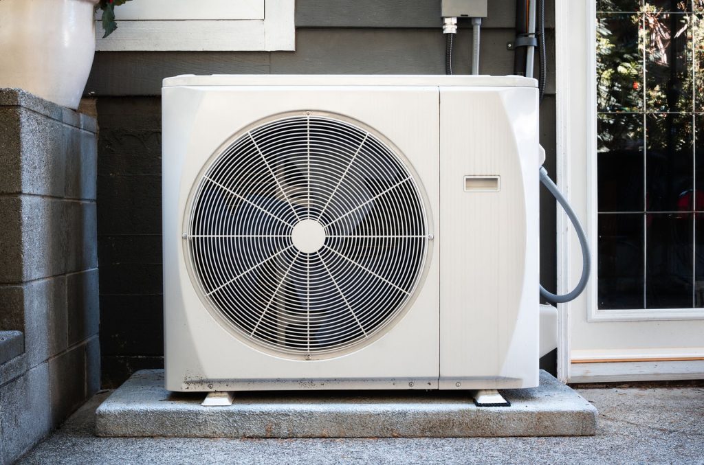 Modern heat pump installed outside a Seattle home to provide energy-efficient heating and cooling.