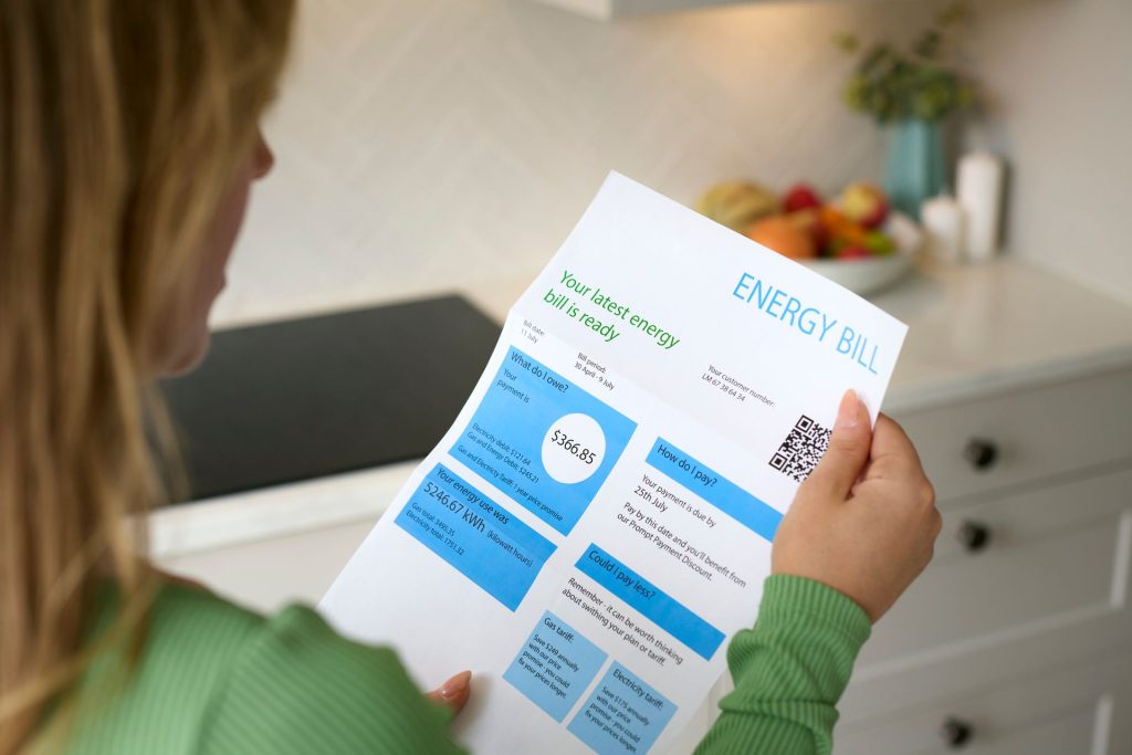Homeowner reviewing high energy bills caused by an inefficient HVAC system in Seattle Washington.