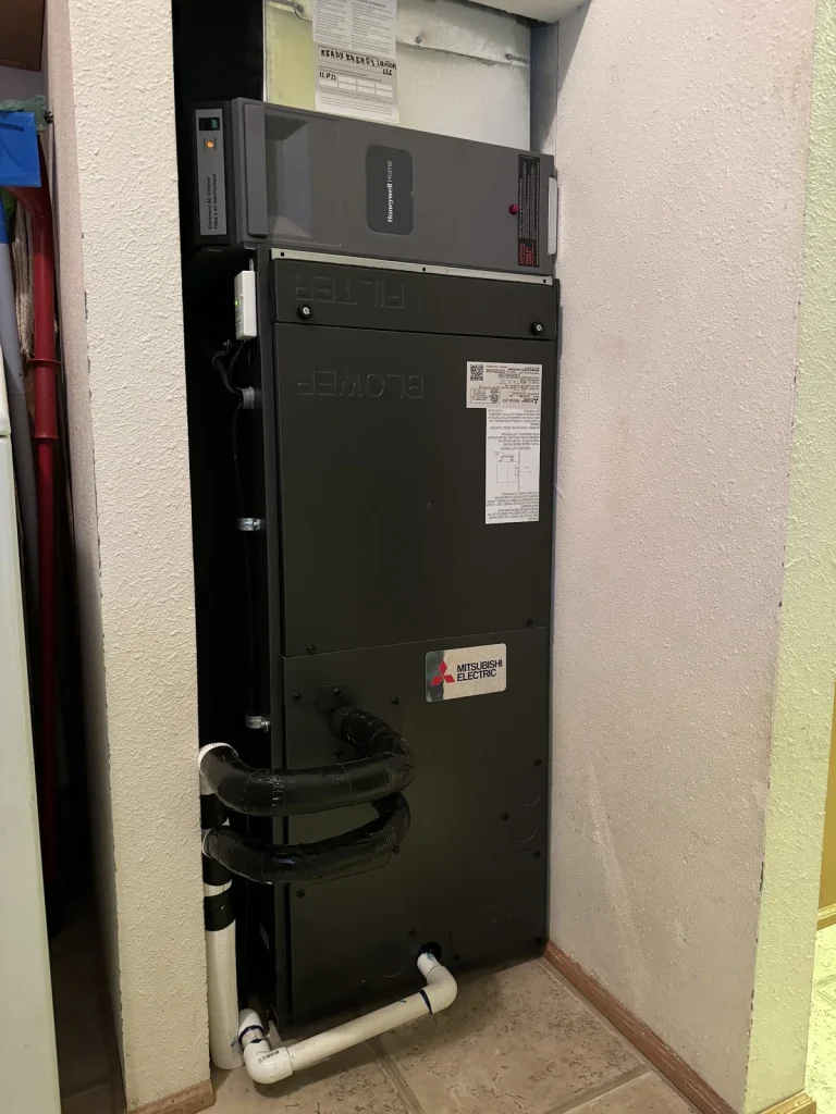 Tall Mitsubishi indoor air handler installed in a utility closet